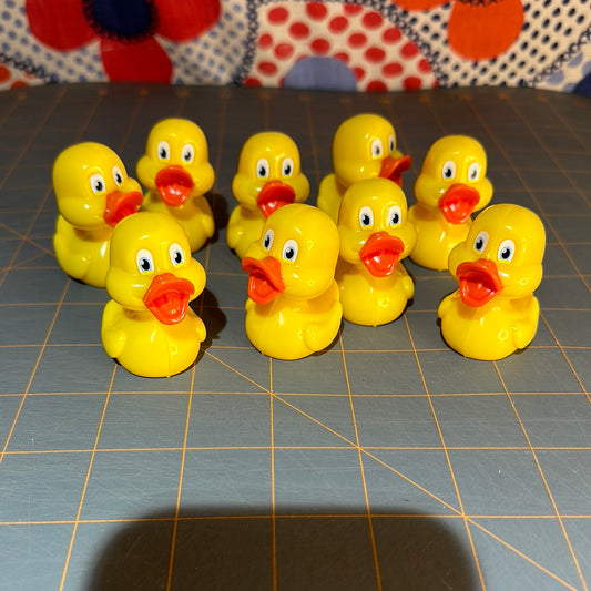 Lot of 9 Plastic Ducks with Memory Shapes on bottom, 2"